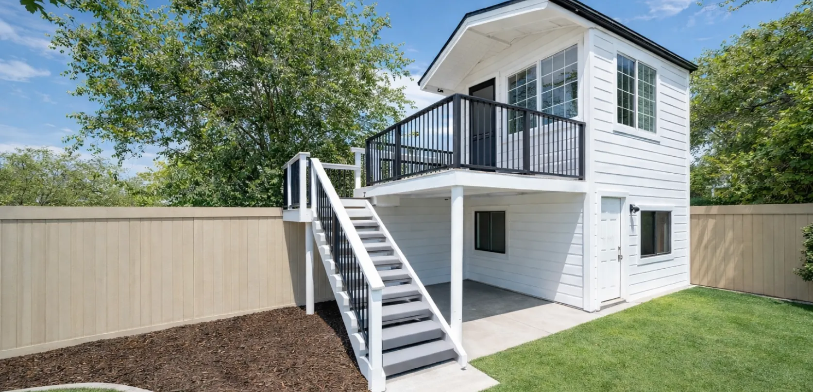 Two story detached ADU with exterior stairs, balcony, and private entrance built in a Dallas TX backyard